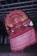 Theyyam or Teyyam ritual dance performing in Kerala Kalamandalam at Cheruthuruthy