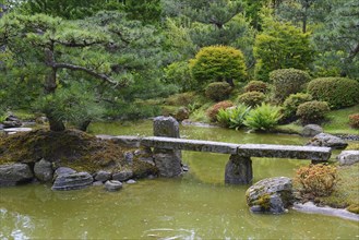 Typical Japanese garden with stone decorations and koi pond