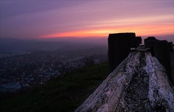 Wooden bench with a view of the city at blue hour