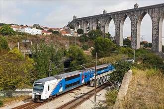 Fertagus train at the aqueduct Aqueduto das Aguas Livres railway in Lisbon