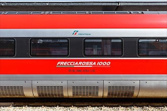 Carriage with logo of Frecciarossa FS ETR 1000 high speed train of Trenitalia at Venezia Santa Lucia station in Venice