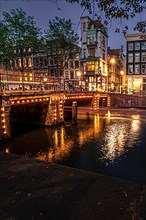Illuminated bridge over the canals at night