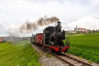 Steam train of the Haertsfeld Museumsbahn Schaettere railway steam train with Neresheim monastery
