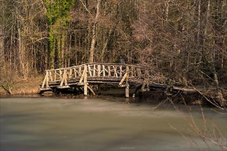 Wooden bridge over icy lake