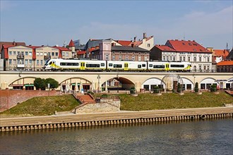 Landsberg an der Warthe town on the river with a Newag Impuls 2 regional train in Gorzow Wielkopolski