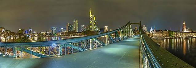 Frankfurt by night at the iron bridge with skyline panorama Germany