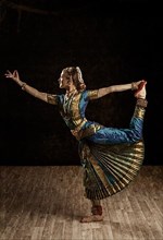 Vintage retro style image of young beautiful woman dancer exponent of Indian classical dance Bharatanatyam