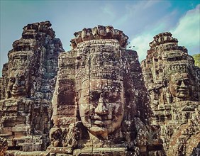 Vintage retro effect filtered hipster style travel image of ancient stone faces of Bayon temple