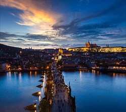 Night aerial view of Prague castle and Charles Bridge over Vltava river in Prague