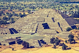 Vintage retro hipster style travel image of Pyramid of the Moon. View from the Pyramid of the Sun. Teotihuacan