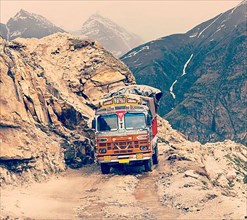 Vintage retro effect filtered hipster style travel image of Manali-Leh road in Indian Himalayas with lorry. Himachal Pradesh
