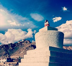 Vintage retro effect filtered hipster style travel image of Whitewashed chorten and Tsemo fort and gompa. Leh