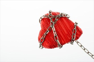Red color heart shaped object in Chain on white background