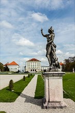 Statue Grand Parterre Baroque garden and the rear view of the Nymphenburg Palace. Munich