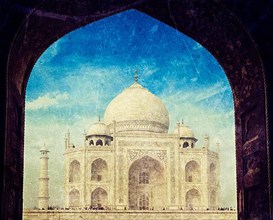 Vintage retro hipster style travel image of Taj Mahal through arch
