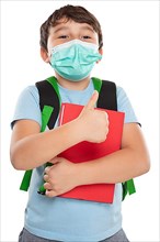 Young pupil child boy with mask against corona virus corona virus showing thumbs up isolated exempted in Stuttgart