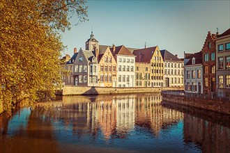 Vintage retro hipster style travel image of canal and medieval houses. Bruges