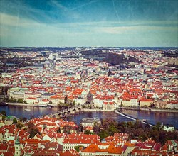 Vintage retro hipster style travel image of aerial view of Charles Bridge over Vltava river and Old city from Petrin hill Observation Tower with grunge texture overlaid. Prague