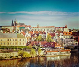 Vintage retro hipster style travel image of Mala Strana and Prague castle over Vltava river. Prague