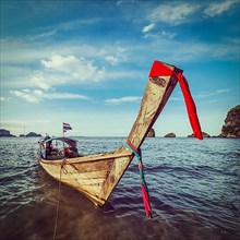 Vintage retro hipster style travel image of Thai Long tail boat on sunset