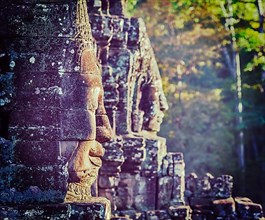 Vintage retro effect filtered hipster style travel image of Ancient stone faces of Bayon temple