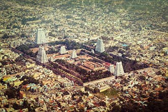 Vintage retro hipster style travel image of Hindu temple and indian city aerial view with grunge texture overlaid. Arulmigu Arunachaleswarar Temple