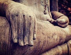Vintage retro effect filtered hipster style travel image of Buddha statue hand close up detail. Sukhothai