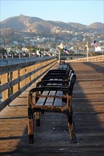 Side view of benches at sunset in Ventura Pier
