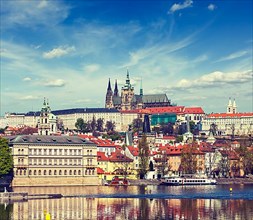 Vintage retro hipster style travel image of Charles bridge over Vltava river and Gradchany Prague Castle and St. Vitus Cathedral