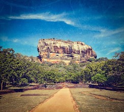 Vintage retro hipster style travel image of famous ancient Sigiriya rock with grunge texture overlaid. Sri Lanka