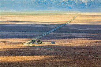 Lonely long road through desert landscape