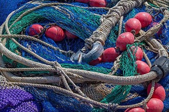 Colourful fishing nets with ropes and floats