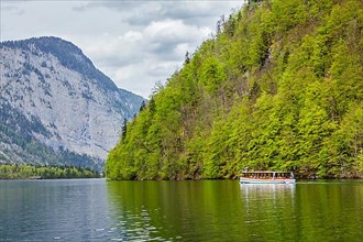 Tourist boat at alpine mountain lake Konigssee