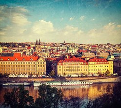 Vintage retro hipster style travel image of aerial view of Prague and Vltava river on sunset