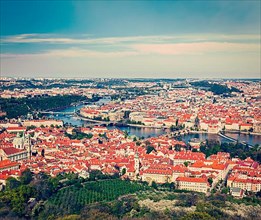 Vintage retro hipster style travel image of aerial view of Charles Bridge over Vltava river and Old city from Petrin hill Observation Tower. Prague