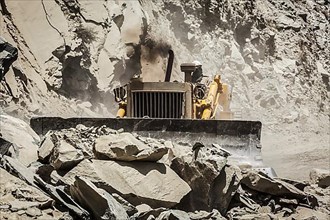 Bulldozer doing mountain road construction in Himalayas. Himachal Pradesh