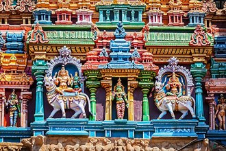 Shiva and Parvati on bull images. Sculptures on Hindu temple gopura tower. Minakshi Temple