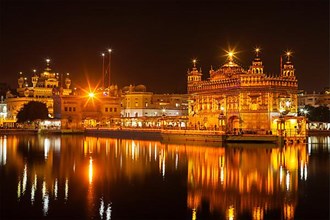 Sikh sacred site gurdwara Sri Harmandir Sahib also known as The Golden Temple also Darbar Sahib illuminated at night. Amritsar