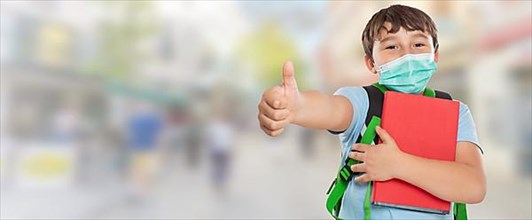 Young Pupil Child Boy With Mask Against Corona Virus Corona Virus In City Showing Thumbs Up With Text Free Space Copyspace in Stuttgart