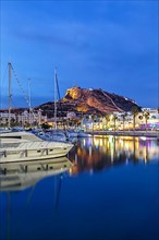 Port of Alicante at night Port dAlacant Marina with boats and view of Castillo Castle Holiday travel city in Alicante
