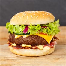Hamburger cheeseburger fast food food on wooden board square in Stuttgart