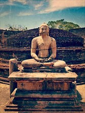 Vintage retro hipster style travel image of ancient sitting Buddha image in votadage with grunge texture overlaid. Pollonaruwa