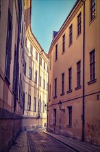 Vintage retro hipster style travel image of Prague street with old houses