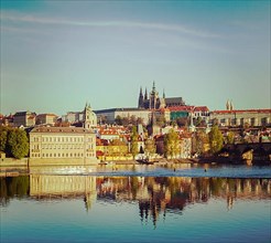 Vintage retro hipster style travel image of Mala Strana and Prague castle over Vltava river. Prague