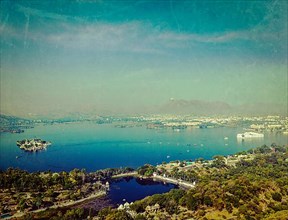 Vintage retro hipster style travel image of aerial view of Lake Pichola with Lake Palace