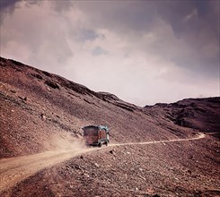 Vintage retro effect filtered hipster style travel image of Manali-Leh Road in Indian Himalayas with lorry. Himachal Pradesh