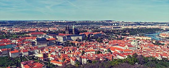 Vintage retro hipster style travel image of aerial panorama of Hradchany the Saint Vitus St. Vitt's Cathedral and Prague Castle. Prague