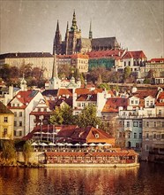 Vintage retro hipster style travel image of Mala Strana and Prague castle over Vltava river with grunge texture overlaid. Prague