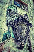 Vintage retro hipster style travel image of Bavarian lion statue at Munich Alte Residenz palace in Odeonplatz with overlaid grunge texture. Munich