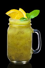 Feijoa cocktail with slices of lime and lemon in mason jar mug isolated on black